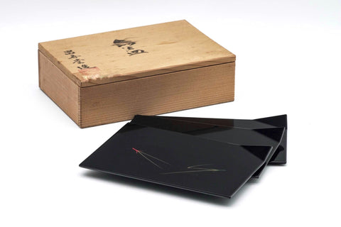 Wooden box with black lacquerware on a white background