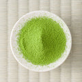 Bright green Betsugi matcha powder in a cream dish, viewed from above.