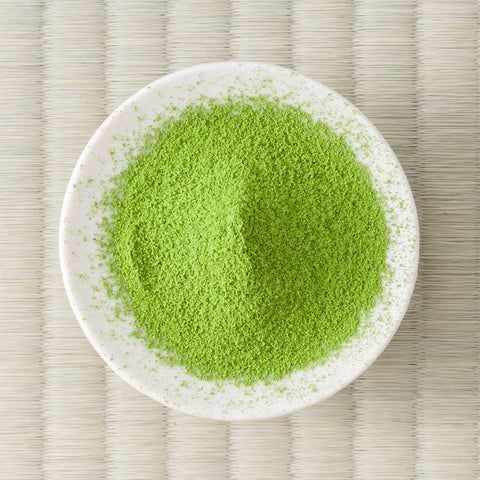 Bright green Betsugi matcha powder in a cream dish, viewed from above.