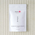 White Tezumi pouch of Handpicked Honyama Yabukita Sencha (やぶきた) on a tatami mat.