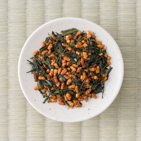 Loose Koshihikari genmaicha on a white dish, dark green leaf mixed with toasted puffed rice