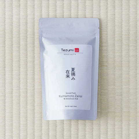 White Tezumi Specialty pouch marked 夏摘み在来 / Kumamoto Zairai Wakoucha, Second Flush, lying flat on a tatami mat