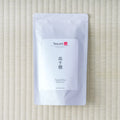 Silver Tezumi pouch of Takachiho Oolong (高千穂) on a tatami mat.