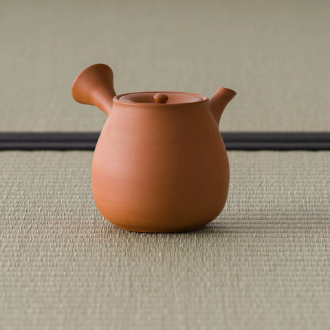 Opposite-side view of the vermilion kyusu with the spout to the left