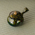 Overhead view of the kyusu showing the gold floral pattern on the lid