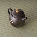 Overhead view of the teapot showing the lid with its gold knob