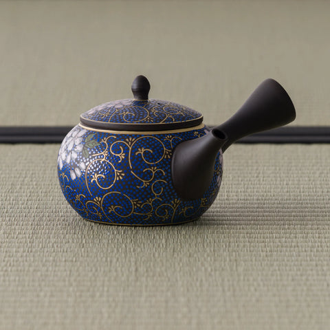 Side view of the dark floral kyusu with the side handle angled toward the viewer