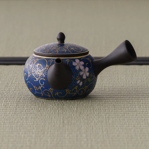 Floral blue-and-gold kyusu teapot, three-quarter view with the spout to the right