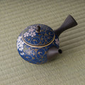 Overhead view of the kyusu showing the blue cherry-blossom pattern on the lid