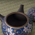 Close-up into the floral kyusu interior showing the strainer at the spout