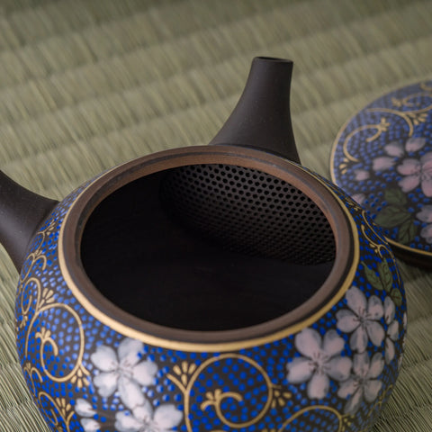 Close-up into the floral kyusu interior showing the strainer at the spout