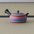 Pink-and-blue kyusu with the dark side handle to the left