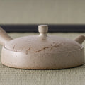 Close-up from above of the kyusu lid showing the thin brushed-line pattern