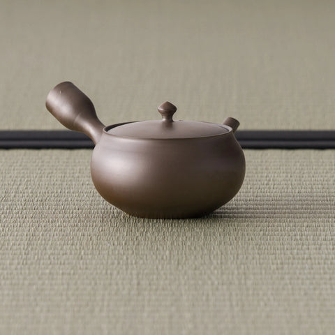 Reddish-brown kyusu with the side handle angled toward the viewer