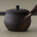 Rear view of the kyusu showing the side handle and knobbed lid
