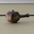 Wood-fired brown kyusu teapot, three-quarter view with the spout to the right