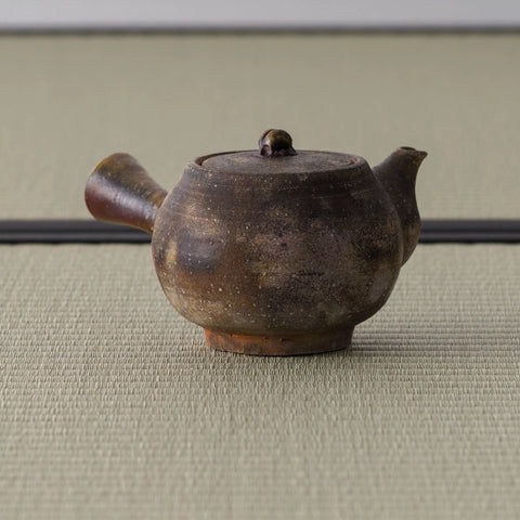 Brown wood-fired kyusu with the spout angled to the left
