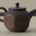 Large brown wood-fired kyusu with a loop handle, cracked texture and lid, close side view.