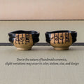 Two shoe-shaped black chawan with painted motifs, alongside a note that handmade pieces vary slightly.