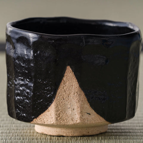 Oharagi Seto-guro matcha bowl, three-quarter view showing the black glaze and exposed foot