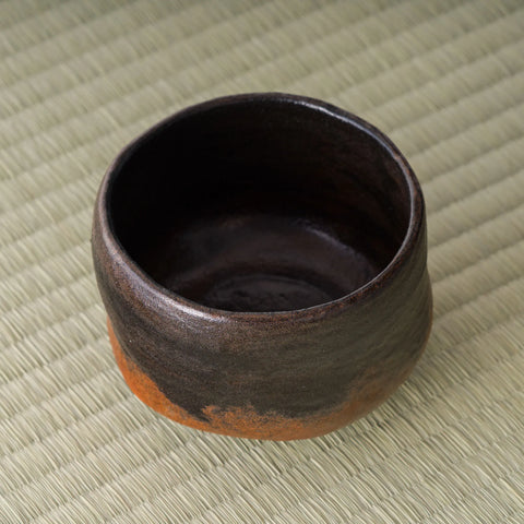 Kuro-raku black raku matcha bowl, overhead view into the dark glazed interior