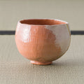 Aka-raku Seppo red raku matcha bowl, front view showing the white snow-peak glaze