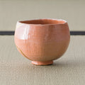 Aka-raku Seppo red raku matcha bowl, front view on tatami