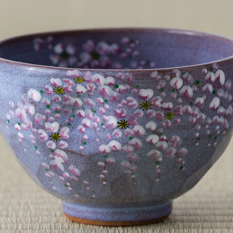 Close-up of the painted weeping cherry on the Purple Weeping Sakura Chawan, white and pink petals with yellow centres