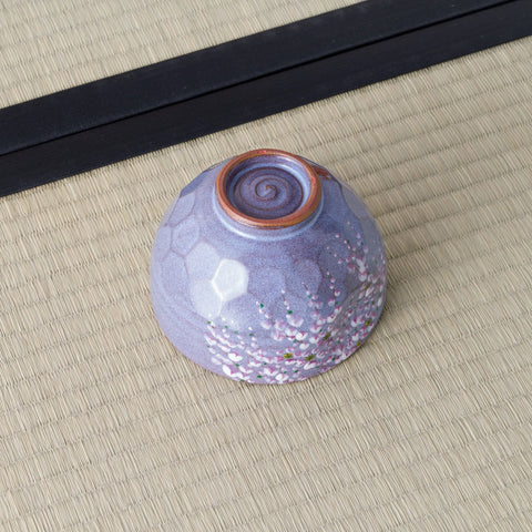 Purple Weeping Sakura Chawan upside down on tatami, revealing a spiralled foot and russet clay rim