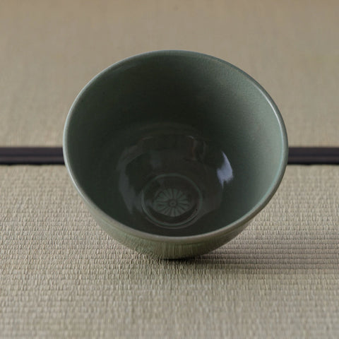 Grey-green celadon tea bowl viewed from above, glazed interior.