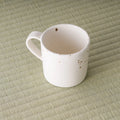 High angle looking into the pink speckled mug showing the glazed interior