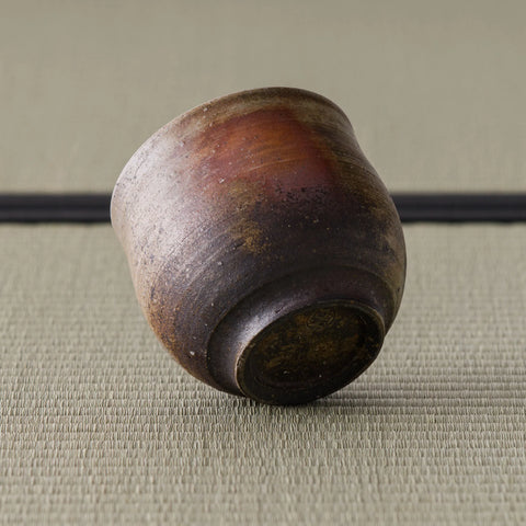 Wood-fired yunomi tipped to show the foot and underside
