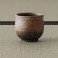 Three-quarter view of the yunomi highlighting the natural ash and flame markings