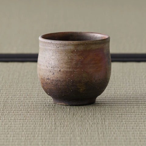 Three-quarter view of the yunomi highlighting the natural ash and flame markings