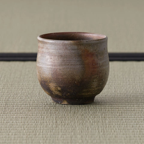 Front view of the wood-fired yunomi showing the mottled brown fire-coloring