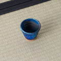 Deep blue speckled cup viewed from above, showing the glazed interior.