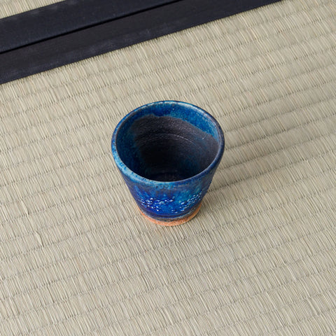 Deep blue speckled cup viewed from above, showing the glazed interior.