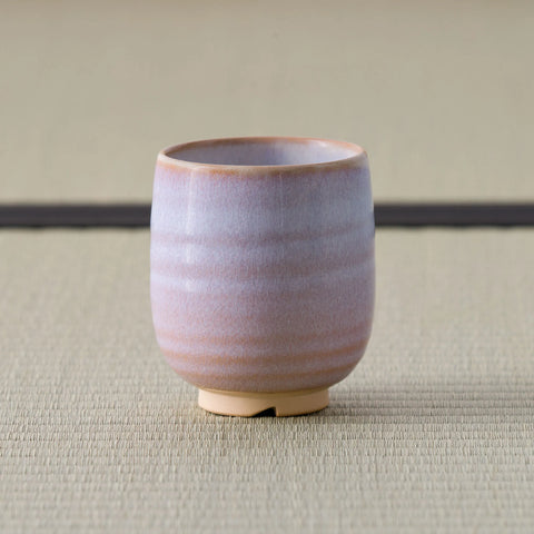 Pale pink-lavender glazed teacup, front view on a tatami mat.
