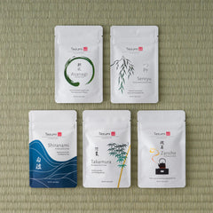 Tezumi Classics Loose Leaf Sample Set - five white Tezumi tea sample pouches arranged on a green tatami mat