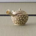 Beige stoneware kyusu with the spout angled forward, showing the white slip dots