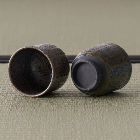The two matching metallic-grey cups, one tipped to show the smooth interior