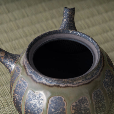 Close-up into the kyusu interior with the lid removed, showing the dark inner wall