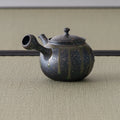 Rear three-quarter of the kyusu showing the side handle and engraved band