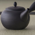 Front view of the black kyusu showing the flush-fitting lid and knob