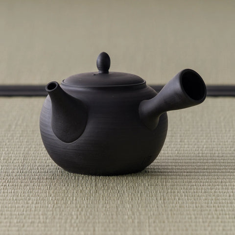 Black clay kyusu with the spout angled toward the viewer