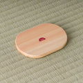 Underside of the oval wooden chataku showing a small red maker's seal