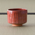 Aka-raku Komachi red raku matcha bowl, front view of the coral-red fluted bowl