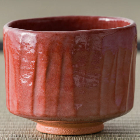 Aka-raku Komachi red raku matcha bowl, front view of the glossy red fluted body
