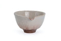 Beige Hagi-yaki spouted matcha bowl showing the pouring lip notch - front three-quarter view