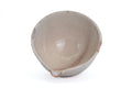 Looking down into the beige Hagi spouted chawan showing the smooth cream-glazed interior - overhead interior view